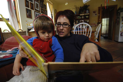 Anne-marie Taplin reading to son George